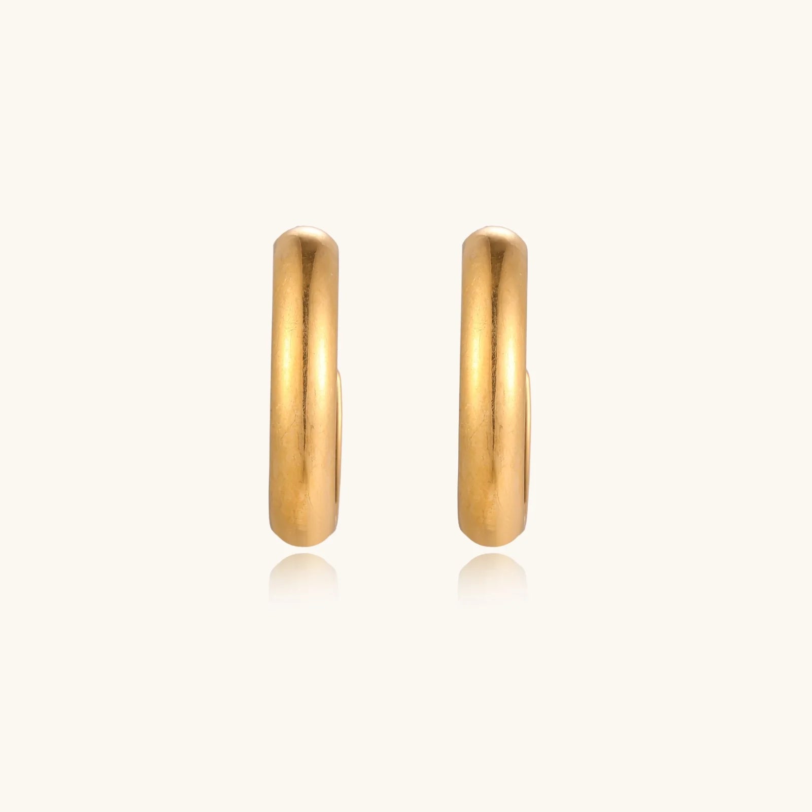 Chunky brushed gold hoop earrings in 14K plated stainless steel on cream background, front and side view.